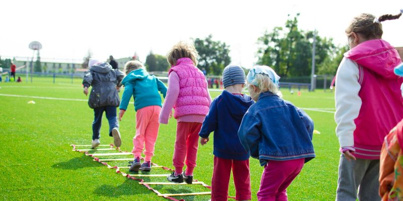 children s team building on green grassland